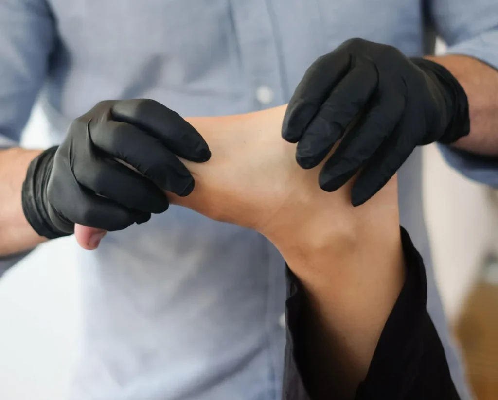 Physical therapist examining a patient’s foot and ankle